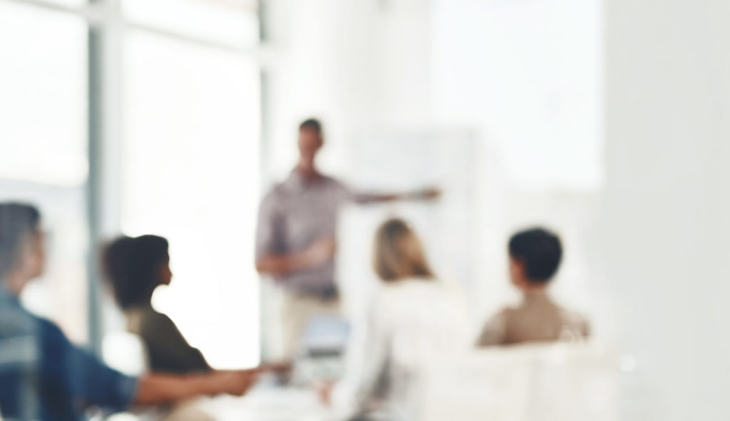 Defocused shot of a group of businesspeople having a meeting in an office