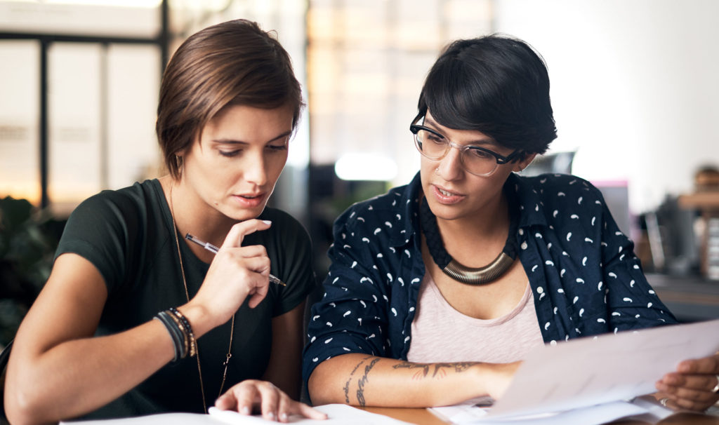 Shot of two women working on a project together in a workshop