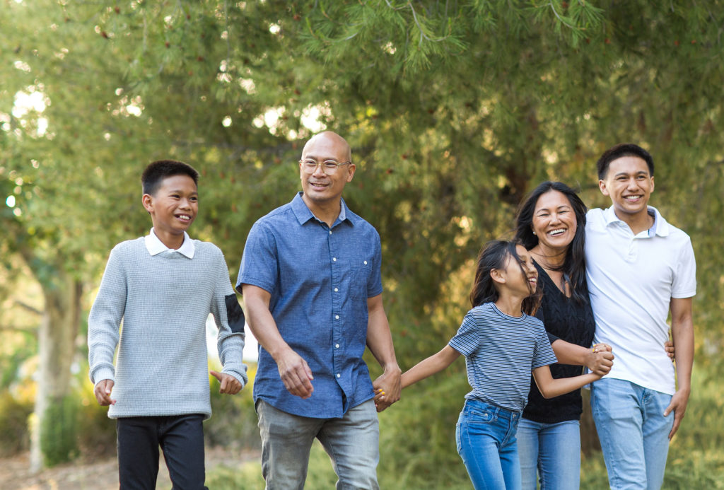 Asian family taking a walk outside and talking.
