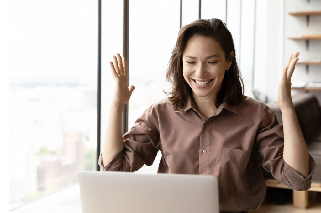 Excited happy business woman celebrating win, success, achieve, high result at laptop, getting job promotion, good news, reward, winning prize, looking at screen, making winner gesture