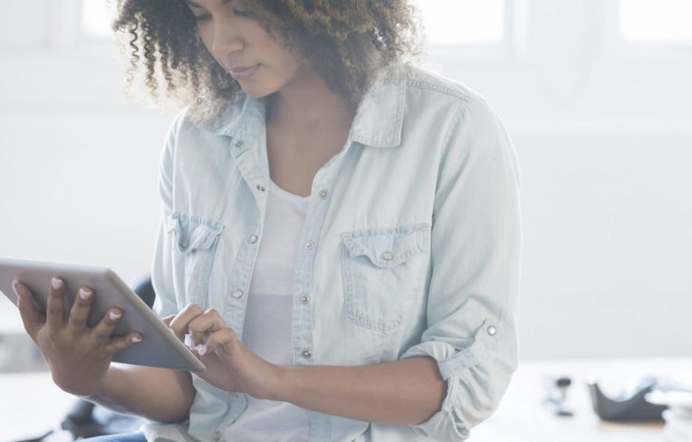 light-filled modern office with female using tablet
