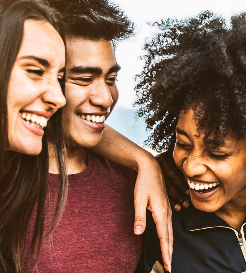 Cheerful young people walking outside talking and having fun - Mixed race friends hanging down the street - Group of teenagers having party celebrating laughing out loud